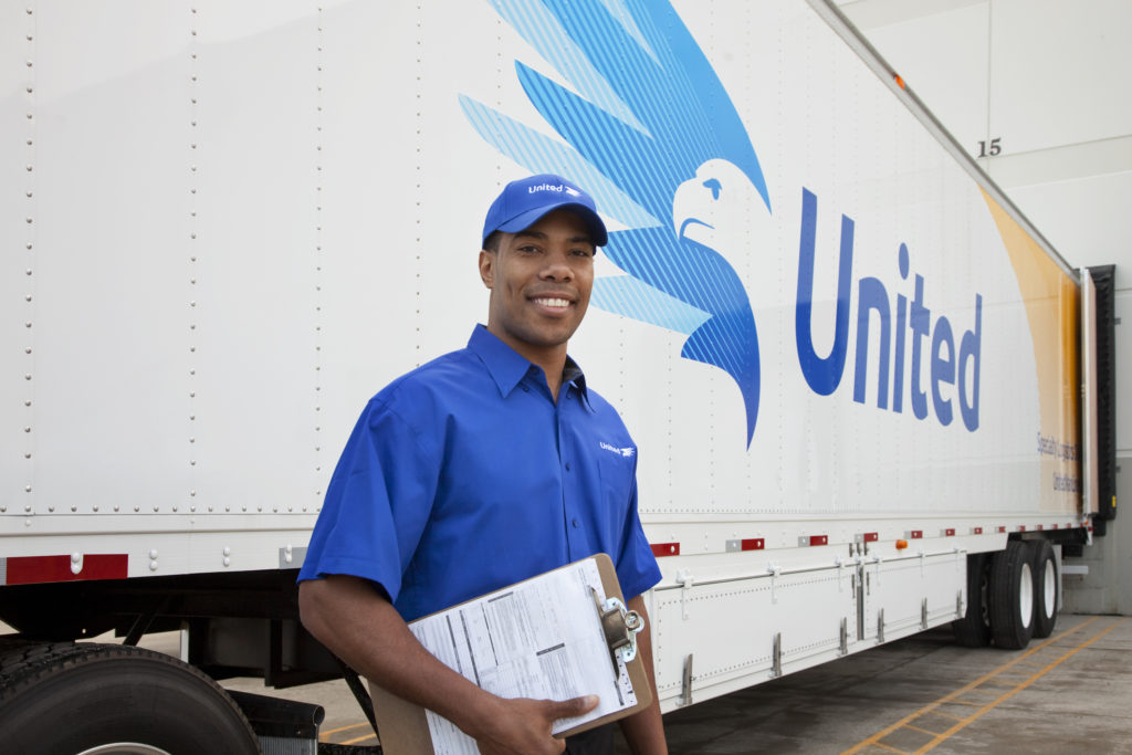 mover posing in front of truck